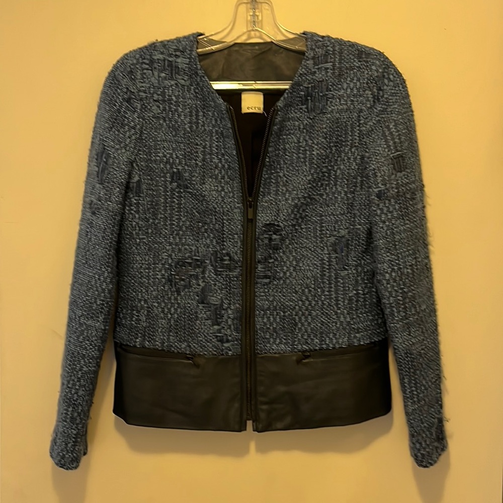 Ecru tweed jacket with leather accents.  Pre-owned with no flaws.